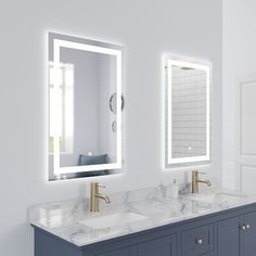 a bathroom with two sinks, mirrors and a large mirror on the wall above it