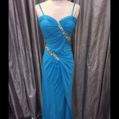 Blue Topaz Faviana Gown, Jersey Fabric (Stretchy) Blue Evening Dress With Ruched Bodice For Party, Blue Ruched Bodice Evening Dress For Gala, Blue Gown With Ruched Bodice For Prom Season, Blue Ruched Bodice Evening Dress For Prom, Blue Prom Evening Dress With Ruched Bodice, Blue Floor-length Evening Dress With Ruched Bodice, Formal Blue Gown With Ruched Bodice, Evening Light Blue Maxi Dress With Fitted Bodice, Light Blue Fitted Bodice Maxi Dress For Evening