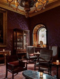 a room with purple walls and chairs in it