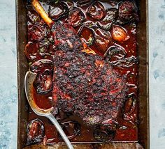 a roasting pan filled with meat and vegetables