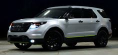 a white suv parked in a parking lot at night