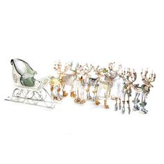 a sleigh filled with lots of different colored glass figurines next to each other