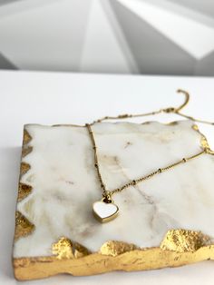 Our Double-sided Heart Necklace, made from 18k gold-plated stainless steel, is sure to make a bold and stylish statement. The timeless color combination of white and black is perfect for any occasion, whether you’re dressing up or down. Wear it with your favorite outfit and let your heart shine! 💖 Features: 18k Gold Plated High-Quality Stainless Steel Tarnish Free White Minimalist Jewelry With Heart Charm, Minimalist White Heart Charm Jewelry, White Heart Charm Jewelry For Everyday, Trendy White Heart Necklace With Adjustable Chain, White Stainless Steel Jewelry For Gift, White Stainless Steel Jewelry For Gifts, White Stainless Steel Jewelry Gift, Trendy Heart Pendant Necklace In Stainless Steel, Trendy Stainless Steel Heart Necklace With Heart Charm