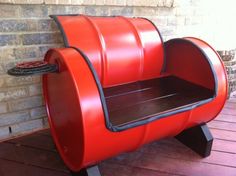 a red barrel shaped bench with a bottle of wine on the top and bottom shelf