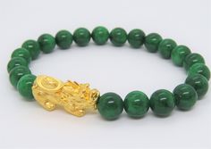 Vintage 24K 999 Pure Gold 3D Pixiu with Green Jadeite Jade Bead Elastic Bracelet ....Marked 999 ...Total of weights 34.1grams...With 21 Green Jadeite Jade Beads 10MM ...Measure of Pixiu H 13.1MM W 28MM...It's in very good condition. #441259 Gold Jade Beaded Bracelets With Gemstones, Traditional Gold Beaded Bracelets With Gemstone Beads, Handmade Gold Jade Beaded Bracelets, Gold Jade Beaded Bracelets, Hand-strung Gold Jade Bracelets, Gold Bracelets With Round Beads For Good Luck, Hand-strung Jade Bracelets In Gold, Gold Symbolic Bracelet With 8mm Beads, Symbolic Gold Bracelet With 8mm Beads