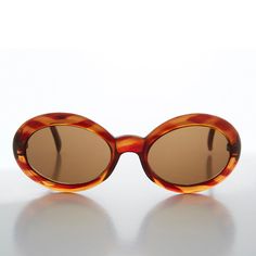 Retro and hip, this oval, clout sunglass features a unique circle temple design. Lightweight and comfortable for all-day wear. New old stock. Never worn. Great condition. UV Protection.NOS deadstock. Made in China.FIT INFORMATION52mm Eye Size22mm Bridge140mm TempleWidth 5 1/4 InchesHeight 2 Inches