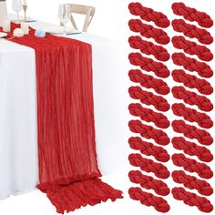 the table is set up with red napkins and place settings