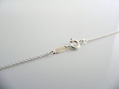 Overview:Offered for sale is a gorgeous Tiffany & Co Sterling Silver Nature Open Flower necklace. The necklace is a wonderful piece that is simple, elegant, and classic all rolled into one. It works perfectly with pretty much any attire your put on, AND adds a nice feminine touch to it. It is a wonderful necklace that fits a lifestyle on the go -- the necklace can be worn to pretty much any occasion! Imagine the piece with your professional office attire ... Now imagine it with jeans or week Elegant Necklace With Sterling Silver Clasp And Round Pendant, Elegant Necklace With Sterling Silver Round Pendant, Classic Pendant Necklace With Sterling Silver Clasp, Luxury Sterling Silver Necklace With Spring Ring Clasp, Classic Pendant Necklaces With Sterling Silver Clasp, Elegant Formal Necklaces With Lobster Clasp, Formal Sterling Silver Necklace, Classic Anniversary Necklace With Spring Ring Clasp, Elegant Sterling Silver Cable Chain Necklace