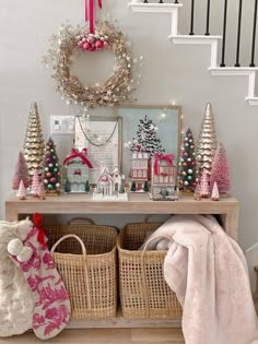 a christmas display with baskets and ornaments on the shelf next to it is an entryway