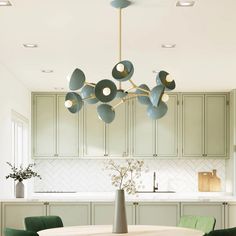 a kitchen with green chairs and a round table in the center, surrounded by cabinets