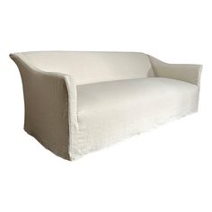 a white couch sitting on top of a white floor