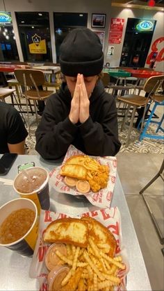 a man sitting at a table covered in food