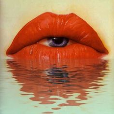 a woman's eye is reflected in the water with red lipstick on her lips