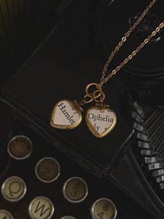 "* This necklace has two small brass lockets that are heart shaped. On each one is a piece of vintage paper that together read, \"Hamlet\" and \"Ophelia\". * No coating over the paper, so do not get wet.  * Gold tone chain.  * Ideal for a Shakespeare lover.  Hamlet & Ophelia locket necklace, Two heart locket necklace, Shakespeare locket, vintage paper locket, dark academia gift Want to see the rest of my shop? www.classicallyromantic.etsy.com" Victorian Brass Necklace With Heart Charm, Vintage Heart Necklace For Mother's Day, Vintage Charm Heart Pendant Necklace For Keepsake, Vintage Charm Necklaces For Gifts, Vintage Charms Necklace For Gift, Heart Pendant Necklace With Vintage Charm For Keepsake, Vintage Charm Necklace As A Gift, Vintage Charm Necklaces With Heart Pendant For Memorial, Vintage Charm Necklace With Heart Pendant For Memorial