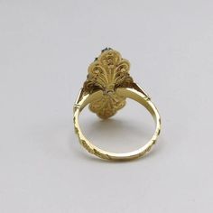 This is part of Chairish’s Fine Jewelry assortment.  A beautiful diamond cluster ring, made of 17 rose cut diamonds against a foil back, with a collet setting of sterling silver in an 18 karat yellow gold ornate band and mount. This ring is remarkable piece of Georgian revival jewellery, made between the 1930s and 1940s. The glimmering bouquet of gems are arranged in this way to form what epitomised the fashion of the Georgian era- the Rivière- a river of light, a flooding of pure, glowing diamo Georgian Cluster Ring, Victorian 14k Gold Ring With Rose Cut Diamonds, Victorian 14k Gold Diamond Ring With Rose Cut Diamonds, Victorian Style Diamond Ring With Diamond Cut, Antique Gold Diamond Ring With Rose Cut Diamonds, Antique Gold Ring With Rose Cut Diamonds, Antique Yellow Gold Rings With Rose Cut Diamonds, Victorian Oval Diamond Ring With Rose Cut Diamonds, Victorian Style Formal Cluster Ring With Rose Cut Diamonds