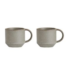 two grey coffee mugs sitting side by side on a white background, one is empty and the other has no lid