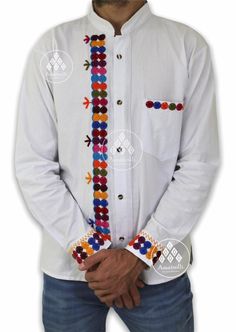 Mexican Handcrafted Shirt type Guayabera with long sleeves. Typical Mexican design. Embroidered by our Chiapanecas artisans by hand on blanket fabric. Handcrafted design work that, although they follow the same pattern, the colors of the embroidery of the shirts can vary from piece to piece. Material: blanket (cotton). Sizes: CH, M, G and EG. Primary color: black and white. Multicolor embroidery by hand. The availability of colors and sizes is limited, images are just examples to illustrate how Casual Multicolor Long Sleeve Kurta, Traditional Long Sleeve Shirt, Traditional Long Sleeve Shirt With Patterns, Long Sleeve Embroidered Folk Shirt, White Long Sleeve Bohemian Shirt, Embroidered Long Sleeve Folk Shirt, Festive Long Sleeve Embroidered Shirt, Traditional White Embroidered Shirt, Long Sleeve Embroidered Shirt For Festivals