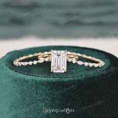 an emerald green velvet box with a diamond ring on it and the top part of the ring