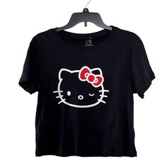 Sanrio Hello Kitty Wink Black Crop Top T-Shirt Condition: Brand New Without Tags Note: Please View All Photos Carefully For Item Description. Thank You. Cute Black T-shirt With Cat Design, Hello Kitty Short Sleeve Top, Y2k Hello Kitty Print Short Sleeve Tops, Hello Kitty Print Y2k Crew Neck Top, Y2k Hello Kitty Print Crew Neck Top, Black T-shirt With Cat Print For Summer, Kawaii Summer Tops With Cat Design, Trendy Hello Kitty Print Crew Neck Top, Y2k Cotton Top With Cat Design