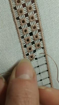 someone is stitching on the side of a piece of fabric