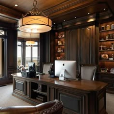 an elegant home office with wood paneling and built - in bookcases