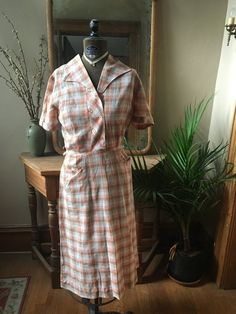 1950's cotton pink and tan gingham dress. Zipper on the side. Has some wear, as shown, and is priced accordingly.Size small Vintage Fitted Plaid Dress For Picnic, Fitted Vintage Plaid Dress For Picnic, Vintage Cotton Plaid Dress, Vintage Gingham Dress With Short Sleeves, Summer Plaid Vintage Dress, Plaid Vintage Summer Dress, Vintage Plaid Dress For Spring Picnic, Fitted Vintage Plaid Dress For Spring, Vintage Cotton Gingham Plaid Dress