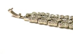 Silver Plated Costume Bracelet  Missing 1 rhinestone by clasp - see picture 3 - not very noticeableMeasures 7-1/4 Inches Long or 18 cmMeasures approximately 3/8" wide or 5 mmTotal Weight: 17.7 Grams082912-386VFEEL FREE TO MESSAGE ME WITH A BEST OFFER OR IF YOU WISH TO SEE MORE PICTURES!We combine shipping where you pay only $1.00 more for any additional items on the same order!_________________________________________________________________________________* Back to Shop Watch and Wares? https:/ Metal Bracelets With Rhinestones For Anniversary, Anniversary Metal Bracelets With Rhinestones, Adjustable Diamond Bracelet With Rhinestones For Wedding, Metal Diamond Jubilee Bracelet For Weddings, Rhinestone Art, Wide Bracelet, Rhinestone Bracelet, Art Deco Design, Clear Rhinestones