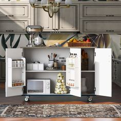 an open cabinet in the middle of a kitchen with lots of cupboards and appliances