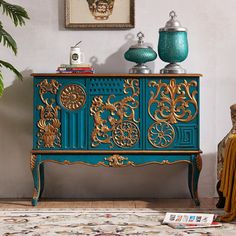 a blue and gold painted cabinet in a living room