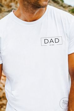 Complete with the ability to include the year of fatherhood, this dad shirt is the perfect gift for the dad in your life! See the sizing chart to ensure you choose your perfect fit. To ensure that your shirt always looks amazing, wash cold inside-out & refrain from ironing directly on the design. - Made with 100% cotton for year-round comfort that is sustainable and highly durable. - The classic fit of this shirt ensures a comfy, relaxed wear while the crew neckline adds that neat, timeless look that can blend into any occasion, casual or semi-formal. - The tear-away label means a scratch-free experience with no irritation or discomfort whatsoever. Note that no refunds or exchanges can be made since we custom create each shirt to your specifications & orders cannot be changed or canceled o Father's Day Family Text Print T-shirt, Personalized White T-shirt For Father's Day, Personalized T-shirt For Father's Day, Customizable T-shirt For Father's Day, White T-shirt For Father's Day Gift, Personalized Crew Neck Tops For Father's Day, Personalized Crew Neck T-shirt For Father's Day, Father's Day T-shirt With Name Print, Father's Day Gift T-shirt With Name Print