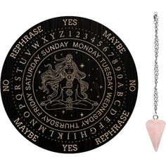 a black and gold zodiac sign on a white background with a pink quartz pendulum necklace