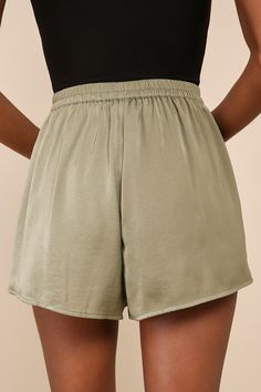 You'll be feeling sweet in the Lulus Extra Love Olive Green Satin High-Waisted Shorts! These comfortable satin shorts begin at a high waist (with a bit of elastic at back for fit) before continuing into a relaxed silhouette. Side seam pockets. Fit: This garment fits true to size. Length: Above mid-thigh. Size medium Inseam: 2.50 Front Rise: 13.50 Waist: Fitted - elastic waist allows stretch. Hip: Not Fitted - room for hips. Fabric: Fabric has no stretch. Unlined. 100% Polyester. Hand Wash Cold. Chic High-waist Shorts With Elastic Waistband, Loungewear Above Knee Shorts, Chic High-waisted Pajama Shorts With Elastic Waistband, Chic Short Length Bottoms With Elastic Waistband, Chic Shorts With Elastic Waistband And Short Inseam, Chic Bermuda Shorts With Elastic Waistband, Chic Pajama Shorts, Chic Bottoms With Waistband In Short Length, Chic Above-knee Shorts With Built-in Liner