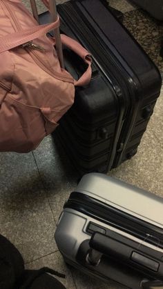 two pieces of luggage sitting on the floor next to each other, one is empty