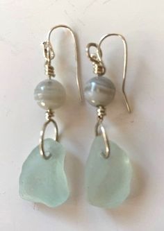 the earrings are made with sea glass and pearls