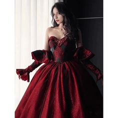 This Gothic Black And Red Wedding Dress With Gloves is sure to make a statement on your special day. Featuring a classic Burgundy Ball Gown silhouette, this dress is crafted from fine, luxurious fabrics and adorned with intricate embroidery. The sweeping skirt is adorned with delicate lace embroidery, while the bodice is tailored with a corset-style top and adjustable ribbon straps. The long, elegant gloves of this dress add a touch of sophistication, while the deep red and black colors lend a d Black And Red Wedding Dress, Wine Wedding Dresses, Red Wine Wedding, Wedding Dress With Gloves, Wedding Dresses Ball Gown Sweetheart, Burgundy Ball Gown, Black And Red Wedding, Dress With Gloves, Satin Bridal Gowns