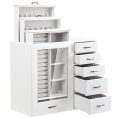 an open white cabinet with drawers next to it