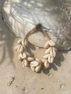 Introducing our new beach accessory: the OCEAN COWRIE SEASHELL BRACELET. Crafted with natural shells sourced from the depths of the ocean in Thailand, this statement piece beautifully captures the essence of the sea. Each shell is carefully combined to create a captivating and unique representation of oceanic beauty. Perfect for beach outfits, honeymoons, resort wear, or gift for your love ones, this choker necklace is a versatile addition to your wardrobe. What sets it apart is our commitment to sustainability and our dedication to working directly with our makers. By choosing this bracelet, you're not only enhancing your style but also supporting ethical craftsmanship and caring for the world. Elevate your beach look with this stunning, eco-friendly accessory and feel good about your imp Ocean-inspired Strand Jewelry For Beach Party, Coastal Beach Bracelet Jewelry, Shell Jewelry For The Beach In Coastal Style, Coastal Shell Jewelry For Beach Season, Coastal Shell Jewelry For Vacation, Beachy Shell Bracelet Jewelry, Shell Jewelry For Beach Season, Bohemian Cowrie Shell Strand Bracelet, Coastal Style Shell Jewelry For Beach Season