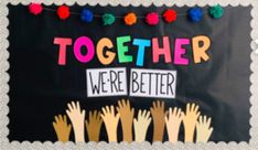 a bulletin board that says together we're better with hands and pom poms