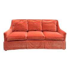 an orange couch with four pillows on it