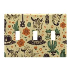 a light switch cover with skulls, cactus and hats on it's side in beige