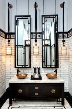 a bathroom with two sinks and mirrors in it