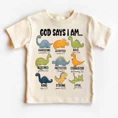 God Says I Am T-Shirt, Christian Shirts for Kids, Dinosaur Kids Shirt, Faith Based Christian Kids Shirt, Sunday School Shirt, Jesus T-Shirt HOW TO ORDER 1️) Please review all the information provided below before placing an order. 2️) Select the shirt type and size. 3️) Select the color of the shirt using the following options. 4) Select your design (Personalization Box) if applicable. 5) Need more items? Add your current item to your cart and if you like to add more items to your order please c Dinosaur Print Graphic Tee With Short Sleeves, Short Sleeve White Tops With Dinosaur Print, White Short Sleeve Tops With Dinosaur Print, White Short Sleeve Top With Dinosaur Print, Unisex White Top With Dinosaur Print, Cotton Short Sleeve Shirt With Dinosaur Print, Unisex White T-shirt With Dinosaur Print, Kids Christian Shirts, Christian Kids Shirts