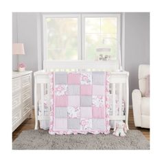 a baby crib bedding set with pink and gray flowers