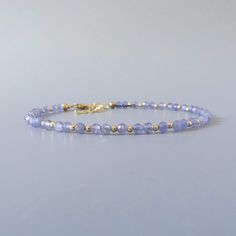 Fall in love with our dainty tanzanite gemstone beaded bracelet, perfect timeless delicate minimalist design, designed to be stacked or worn on its own. Will make a thoughtful birthday, christmas. anniversary gift for your wife, mother, sister, daughter, or friend. Your purchase will arrive elegantly packed  in a gift-ready suede storage bag  and will include a complimentary cleaning cloth. Treat yourself or your loved ones with this high-quality handmade jewelry gift.  D E T A I L S -Genuine an Lavender Bracelets With Tiny Beads For Gift, Elegant Purple Beaded Bracelets With Tiny Beads, Elegant Lavender Bracelets With Faceted Beads, Elegant Lavender Beaded Bracelets With Faceted Beads, Elegant Lavender Beaded Bracelets With Gemstone, Elegant Lavender Beaded Bracelet With Faceted Beads, Elegant Lavender Gemstone Beaded Bracelets, Dainty Gemstone Jewelry, Tanzanite Bracelet