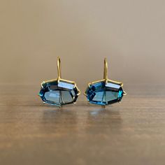 Deep blue hues and flashing facets are framed by rich yellow gold in this head-turning pair. 18k yellow gold London blue topaz, 17mm x 13mm (5/8" x 1/2") Earrings hang 7/8" from the ear Each earring weighs 3.5g Luxury Blue Topaz Brilliant Cut Earrings, Luxury Blue Topaz Jewelry With Matching Earrings, Luxury Octagon Earrings For Formal Occasions, Luxury Modern Blue Topaz Earrings, Luxury Multi-stone Blue Topaz Earrings, Luxury Octagon Topaz Jewelry, Luxury Faceted Topaz Jewelry, Luxury Blue Cabochon Earrings, Luxury Blue Topaz Dangle Earrings