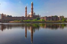 a large body of water with two towers in the background and buildings on both sides