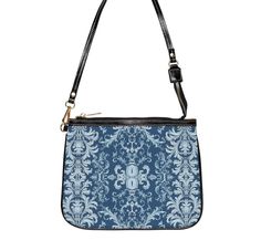 This unique and vibrant shoulder bag adds a chic touch to any outfit. Its compact size (10"w x 8"h) and lightweight construction makes it the perfect accessory for carrying around your essentials in style. Our one of a kind purse features an archival fabric design in baroque flourishes of sapphire, sky and pale blues. This gorgeous design is printed onto high-grade vegan leather and shipped to you by our top-rated production partner. We also offer the coordinating vegan wallet: https://thecheekyshedonist.etsy.com/listing/1680599038 .: 100% high-grade vegan leather exterior .: Polyester lining + 20-inch black strap .: Two open pockets inside .: Gold-toned zipper and hardware .: Original + unique art history design exclusively available at The Cheeky Shedonist  Care instructions: avoid prolo Trendy Rectangular Shoulder Bag With Zipper Pouch, Trendy Shoulder Bag With Zipper Pouch, Blue Rectangular Baguette Bag With Adjustable Strap, Luxury Crossbody Shoulder Bag With Zipper Pouch, Elegant On-the-go Shoulder Bag With Zipper Pouch, Chic Crossbody Shoulder Bag With Zipper Pouch, Blue Evening Shoulder Bag With Adjustable Strap, Blue Shoulder Bag With Adjustable Strap For Evening, Evening Blue Shoulder Bag With Adjustable Strap