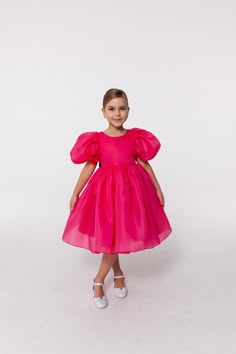 Stylish and stunning full skirt dress for a little princess in a splendid fuchsia colour decorated with the cutest black bow. The dress has an open back and trendy puffy half sleeves.  This kids dress will work well for any special occasion: birthday, kids party, wedding, communion, baptism, any other event.  The lining is 100% cotton for safety and comfortable fit. *Please note that colors may slightly vary depending on your monitor settings. Bright pink girl dress, fuchsia kids dress, organza girl dress with sleeves, kids bridesmaid dress, special occasion dress for girls You can find more gorgeous girl dresses in my Sweet Princess Dress shop by following this link: https://www.etsy.com/shop/SweetPrincessDress The dress is made from high-quality fabrics. Please ensure you send measuremen Pink Princess Bridesmaid Dress For Wedding, Princess Style Pink Bridesmaid Dress For Wedding, Pink Frocks For Kids, Pink Pageant Dress With Fitted Bodice, Spring Princess Dress With Fitted Bodice For Bridesmaid, Pink Princess Bridesmaid Dress, Pink Tulle Pageant Dress With Fitted Bodice, Elegant Pink Tulle First Communion Dress, Pink Princess Style Gown For Fancy Dress