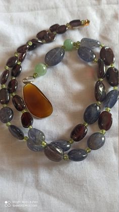 Vintage 340 Carat Fine Quality Natural Iolite, Garnet Multi Gemstone Beads Smooth Oval Shape 30 Inch With Pendent Necklace Stone :Natural Iolite, Garnet Multi Gemstone Shape :- fancy oval Necklace - 30 inch 1 line string Size :- 7x10mm to 12x16mm Weight :- 340 carat Polish :- Handmade Purity :- 100% Natural Gemstone color -brown,red,gray makes a great gift for your loved ones. Click below to see live stock: https://www.etsy.com/au/shop/ShakugemsStore?ref=search_shop_redirect If for any reason yo Oval Agate Gemstone Bead Necklaces, Oval Agate Gemstone Beaded Necklaces, Amber Oval Beads Gems And Cabochons For Gifts, Amber Oval Beads, Gems, And Cabochons For Gifts, Oval Beaded Necklaces With Natural Stones For Gifts, Oval Amber Necklaces With Natural Stones, Oval Amber Necklace With Natural Stones, Brown Oval Natural Stone Necklace, Oval Natural Stones For Beads, Gems, And Cabochons