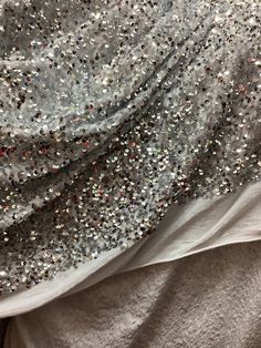 "THIS IS Most elegant luxurious mulberry white sequins velvet with silver sequins 4way stretch  COLOR: white velvet with silver sequins  WIDTH : 60\" LENGHTE ; SOLD EVERY YARD MULTIPLE YARDS ARE ONE CONTINUOUS CUT  CARE : DRY CLEAN ONLY  NEED MORE THAN 20 YRDS AND UP PLEASE SEND US EMIL AND WE CAN ACCOMMODATE YOU SO YOU CAN COMPLETE YOUR PARTICULAR PROJECT  DISCLAIMER : WE HAVE MADE AN AFFORT TO PROVIDE FABRICS IMAGES THAT COLSELY REPRESENT THE FABRICS HOWEVER DUE TO ALL THE POSSIBLE VARIANTS (e,g,light source monitor quility .etc,) WE CAN NOT GURANTEE THAT THE FABRIC IMAGES ACCURATELY REPRESENT THE TRUE FABRICS COLOR . thank you for your purchase  NO RETURNS OR EXCHANGES" Silver Sequin Glitter Dress For Evening, Silver Contrast Sequin Dress For Party Season, Silver Sequin Dress With Contrast Sequin For Holiday, Fitted Silver Sequin Fabric With Shimmer, Silver Holiday Sequin Dress With Contrast, Silver Sequin Dress With Contrast For Holiday, White Glamorous Sequin Fabric With Rhinestones, Glamorous White Sequin Fabric With Rhinestones, White Sequin Dress With Contrast For Party Season